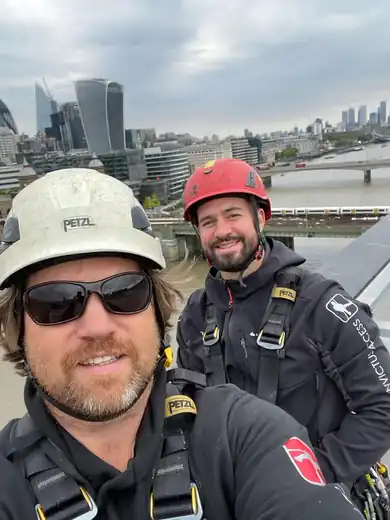 Ryan Hawkins on a London roof with the Invictus team, the City skyline behind